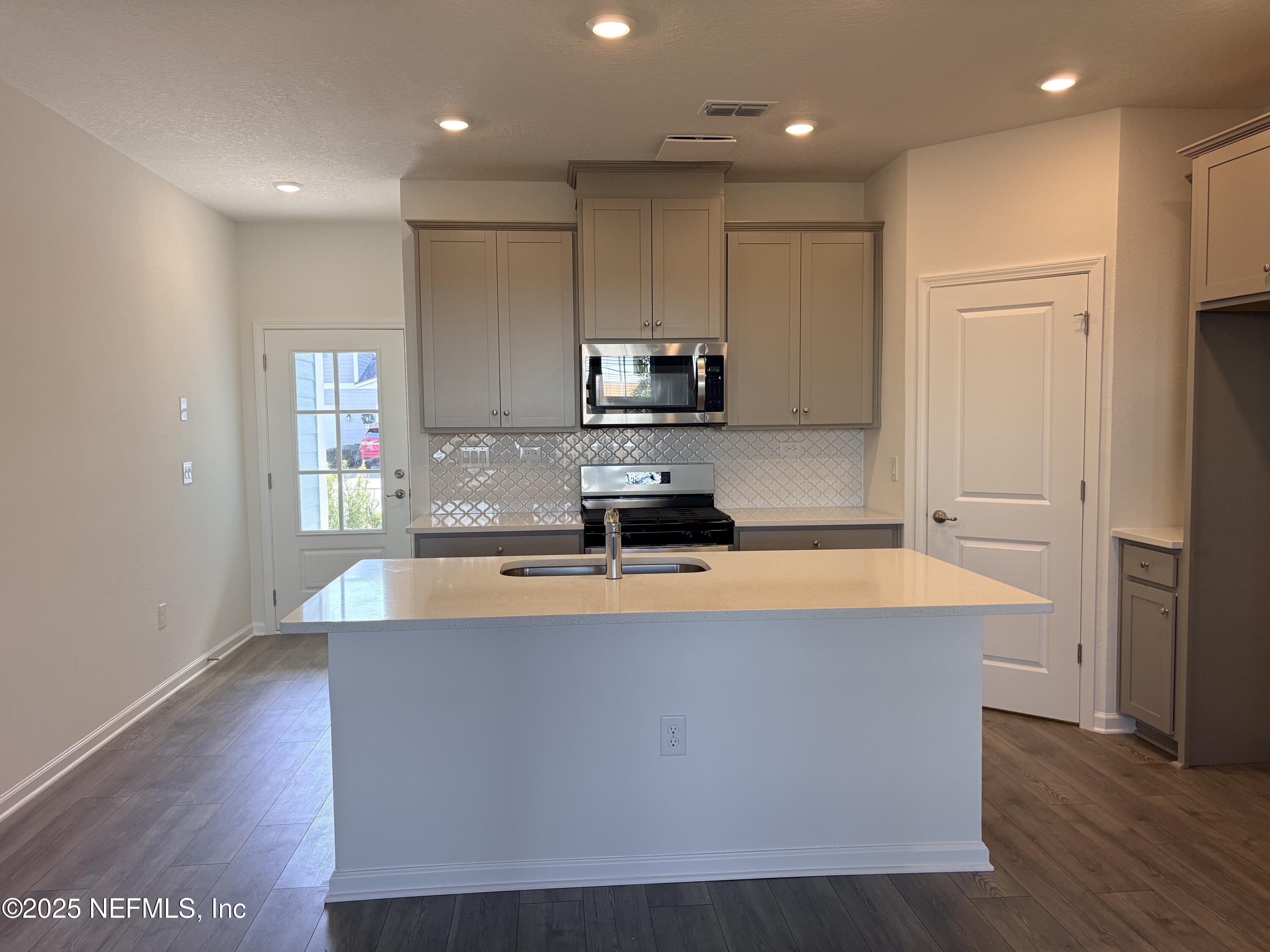 193 Brandon Lks Drive St. Augustine, FL 32092 - Photo 2 of 4 a large kitchen with stainless steel appliances a large counter top and a stove top oven