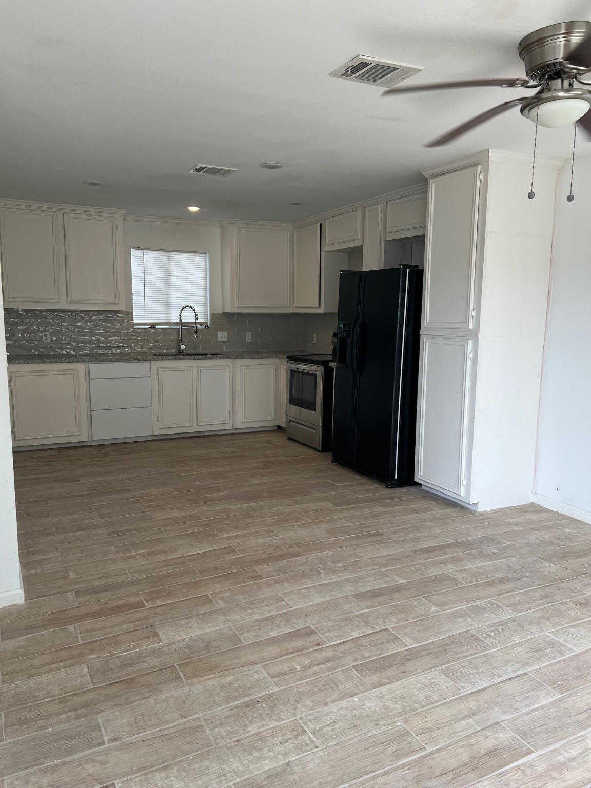 4242 10th Avenue Port Arthur, TX 77642 - Photo 7 of 13 a view of kitchen with refrigerator and window