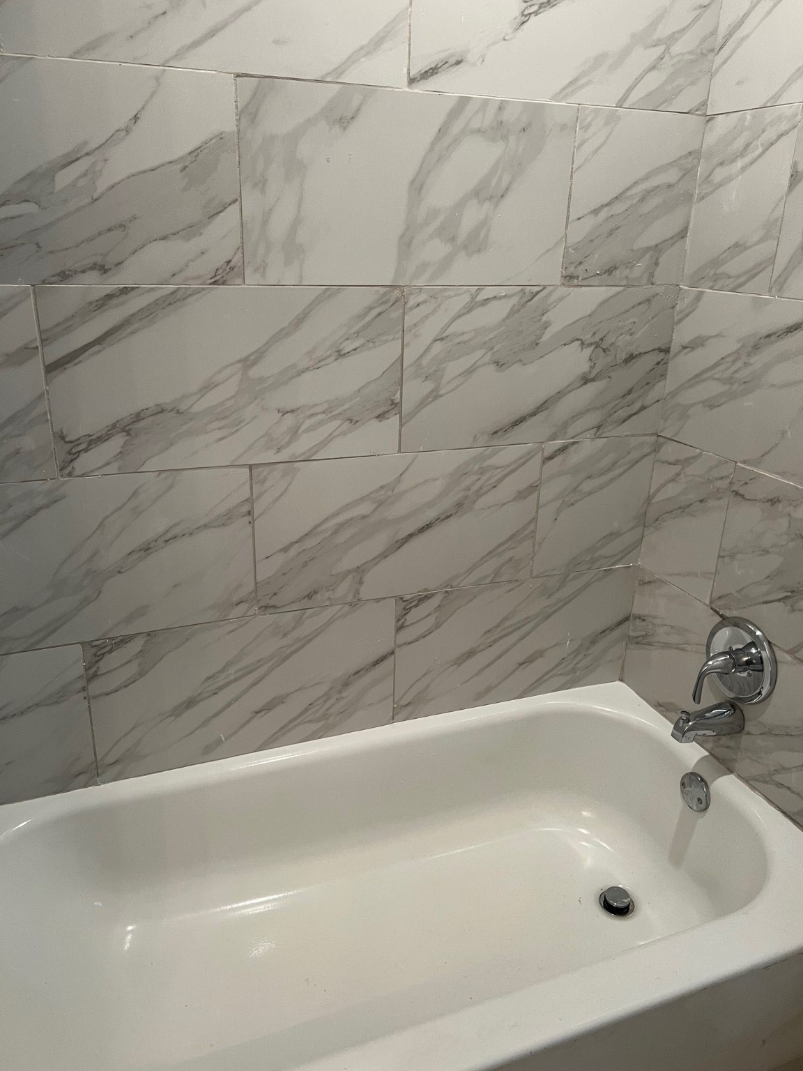 4242 10th Avenue Port Arthur, TX 77642 - Photo 10 of 13 a bathroom with a white bath tub and a shower