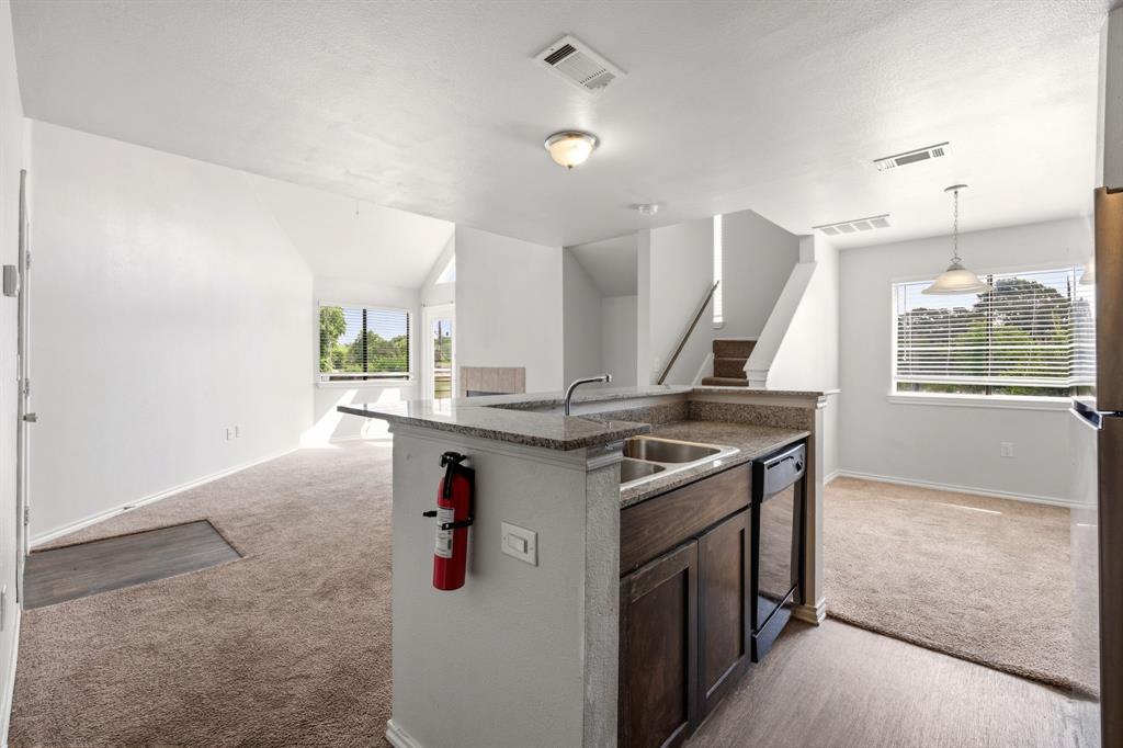 9837 Walnut Street, Unit S203 Dallas, TX 75243 - Photo 7 of 26 The kitchen features a double basin sink, dishwasher, and granite countertops