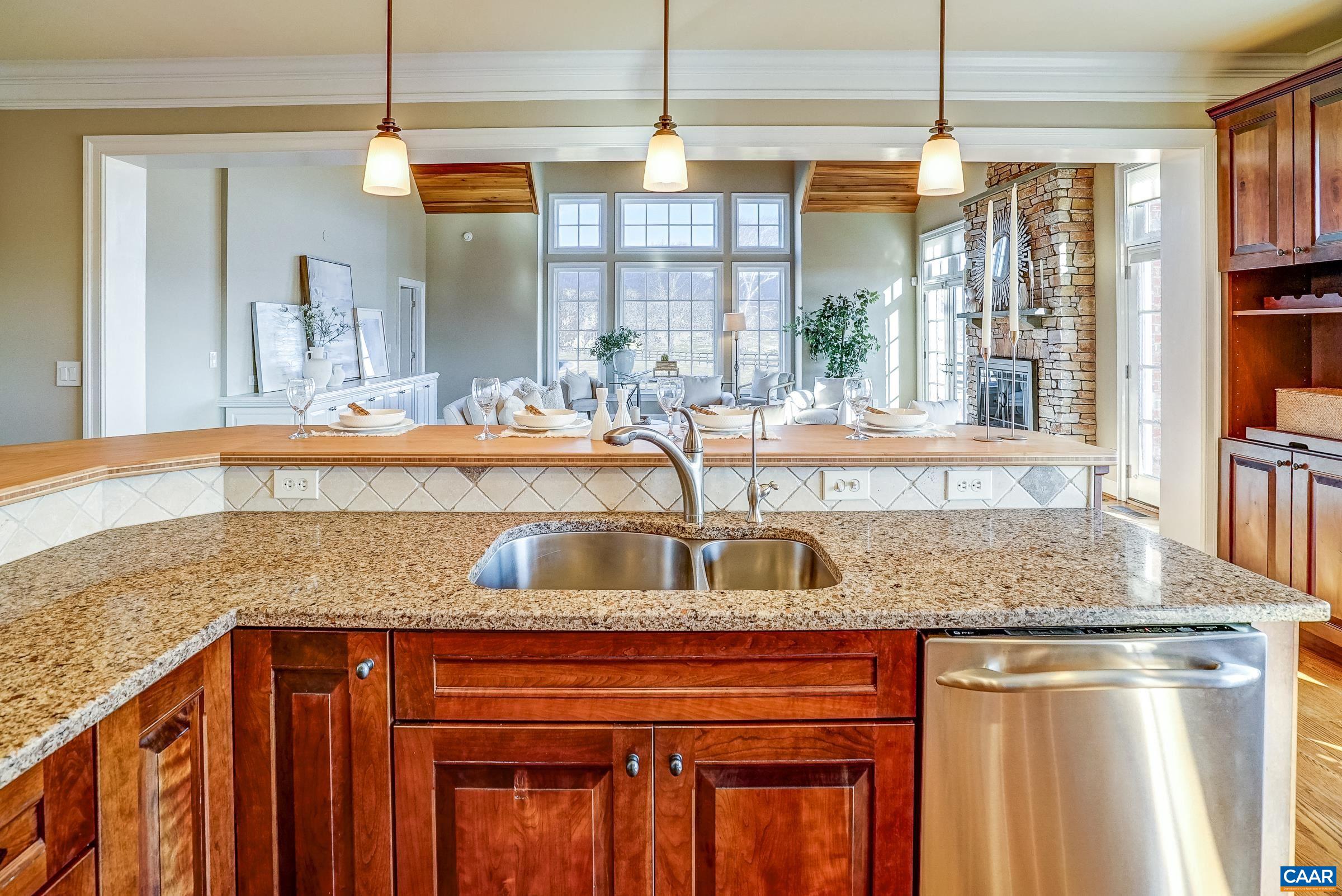 801 Half Mile Branch Road Crozet, VA 22932 - Photo 21 of 69 a kitchen with stainless steel appliances granite countertop a sink a stove and a wooden floor