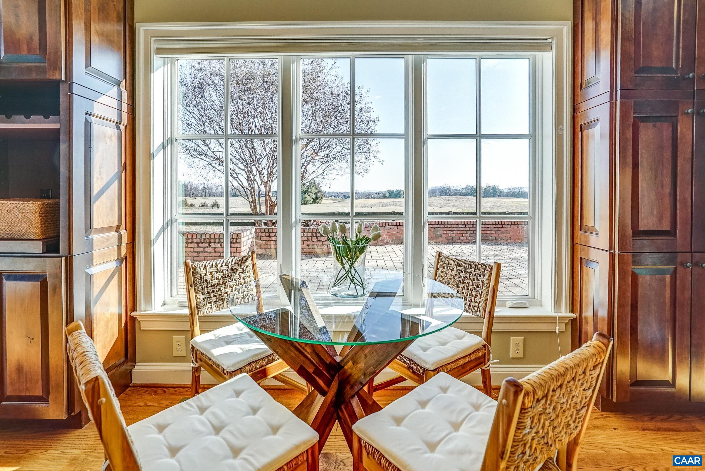 801 Half Mile Branch Road Crozet, VA 22932 - Photo 26 of 69 a dining room with furniture large windows and wooden floor