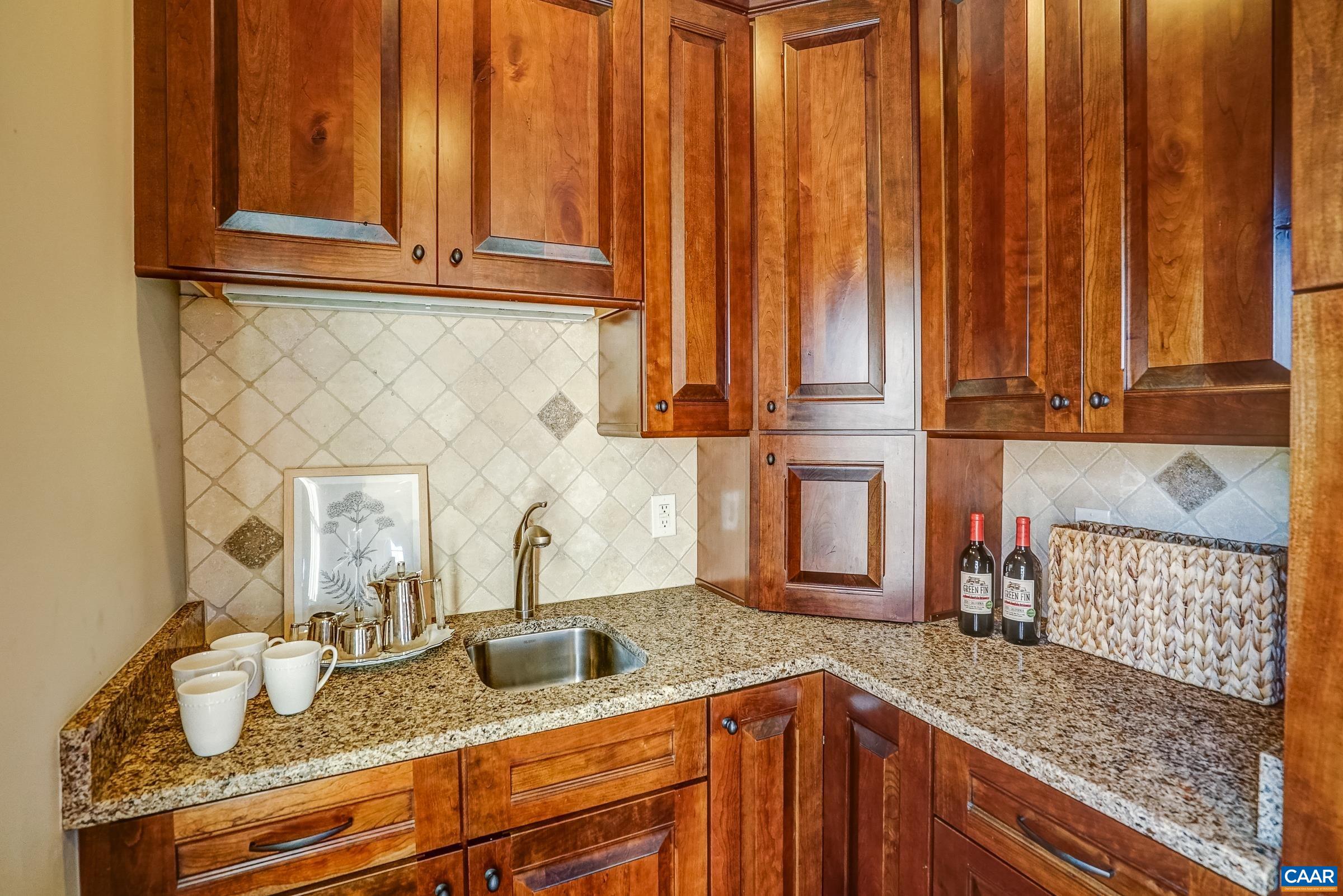 801 Half Mile Branch Road Crozet, VA 22932 - Photo 27 of 69 a kitchen with granite countertop wooden cabinets and sink