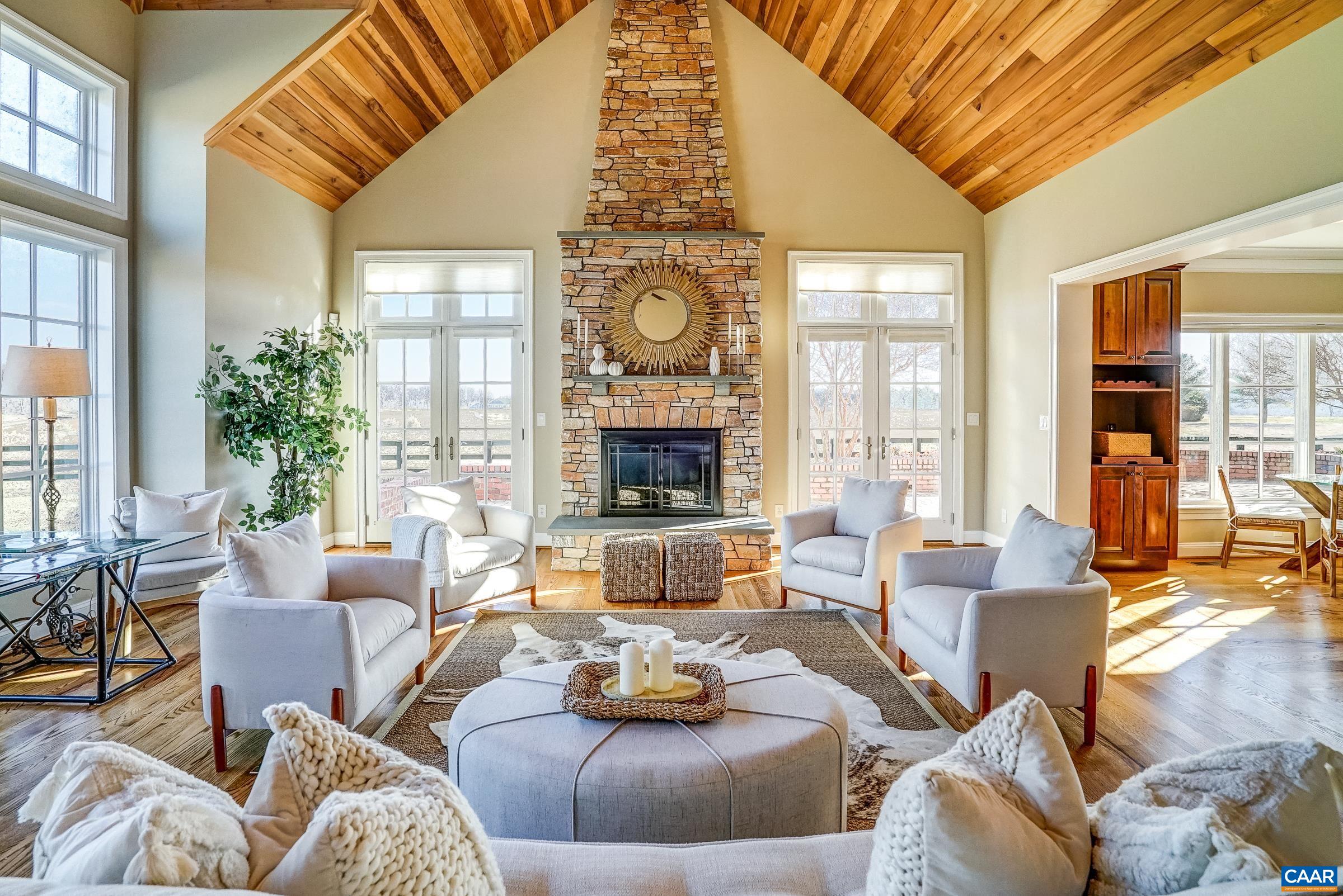 801 Half Mile Branch Road Crozet, VA 22932 - Photo 29 of 69 a living room with furniture fireplace and large windows