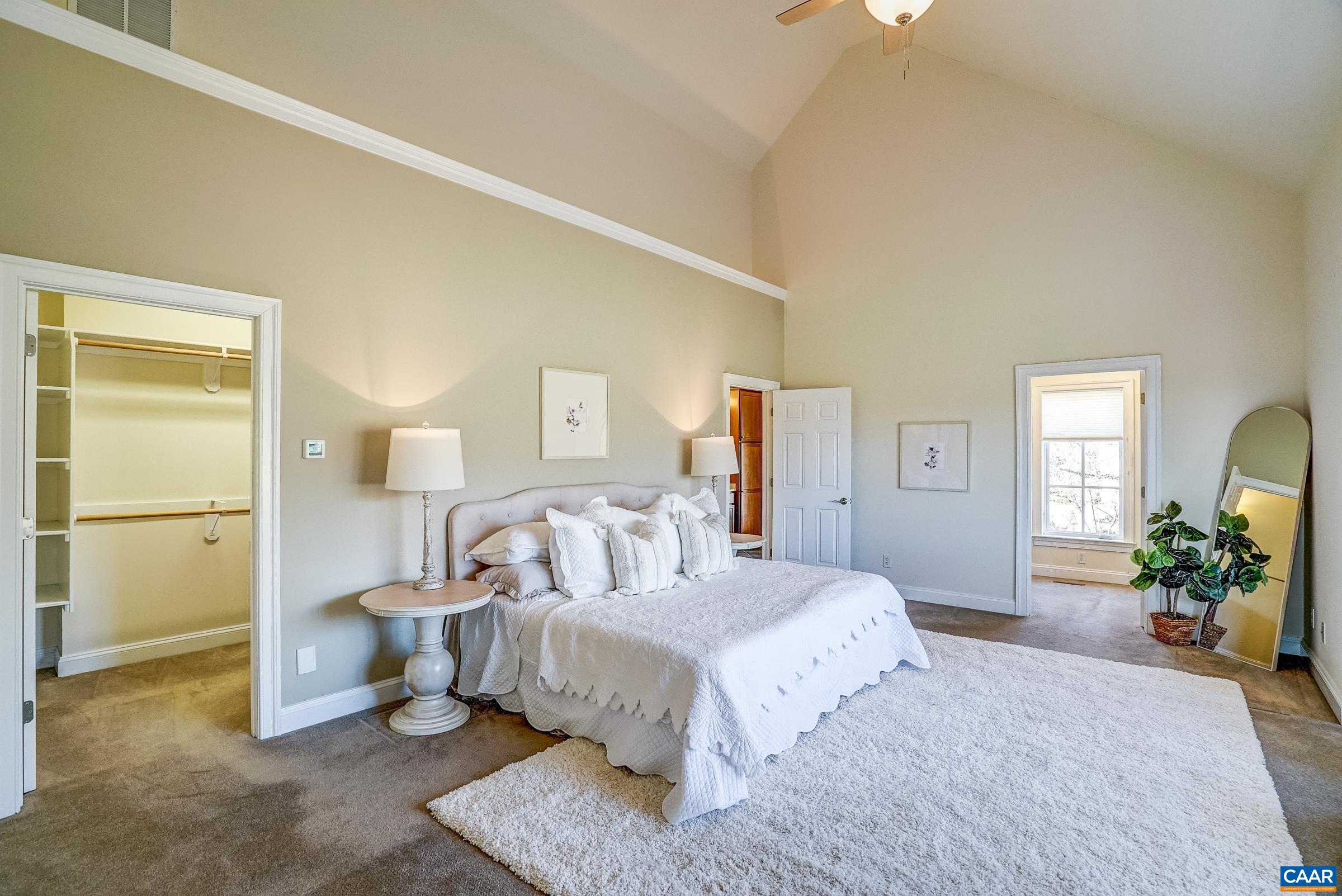 801 Half Mile Branch Road Crozet, VA 22932 - Photo 34 of 69 a bedroom with a bed a mirror on dresser and a window