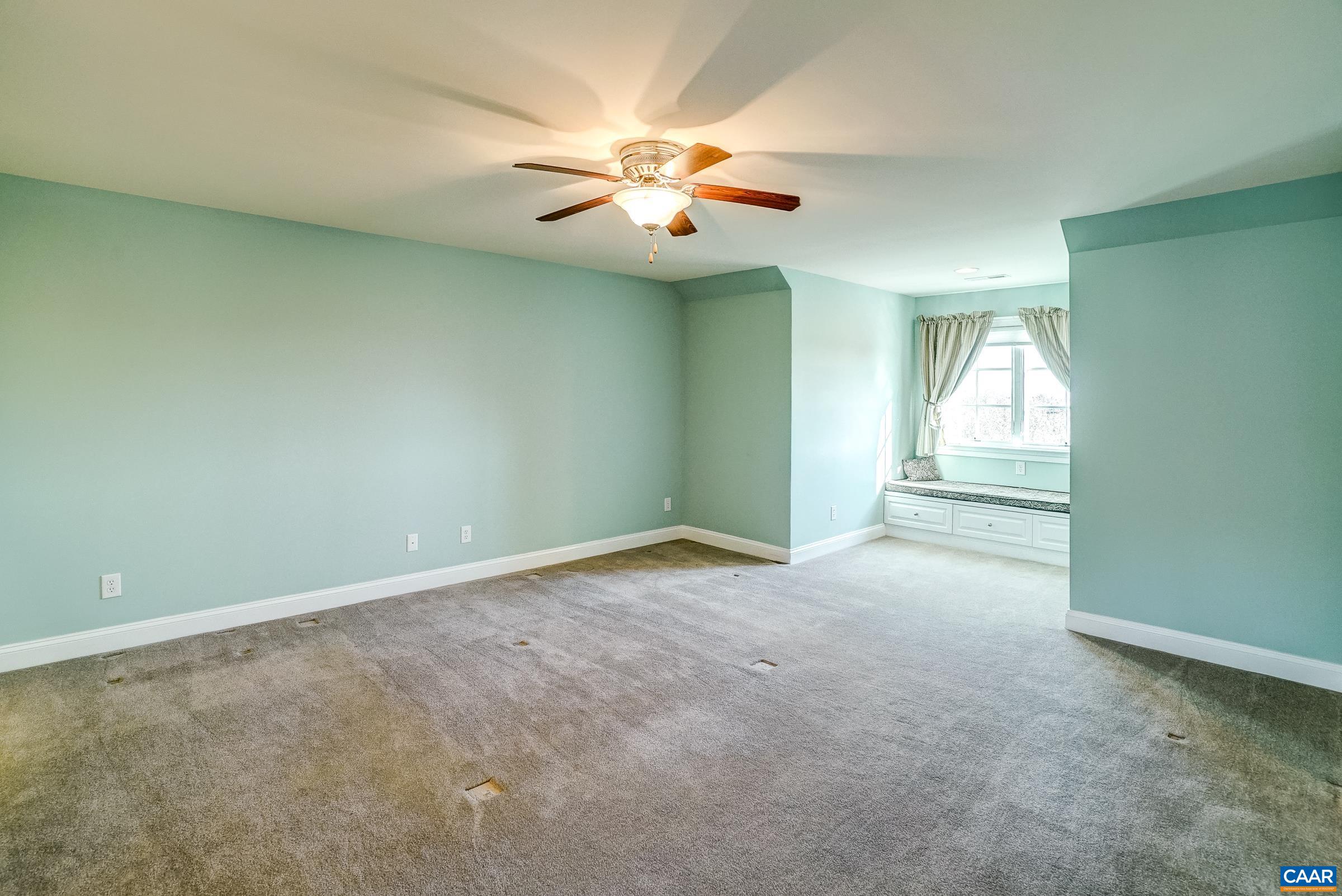 801 Half Mile Branch Road Crozet, VA 22932 - Photo 47 of 69 an empty room with chandelier fan and windows