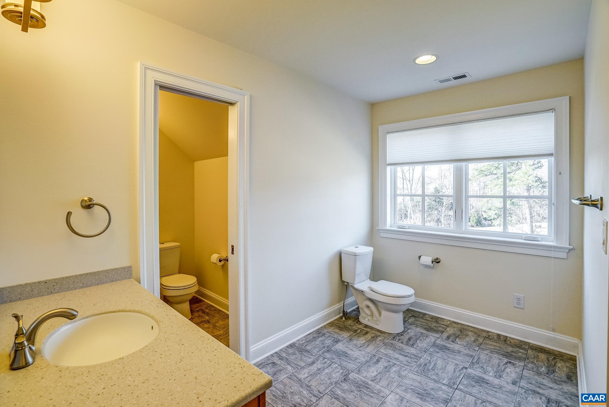 801 Half Mile Branch Road Crozet, VA 22932 - Photo 51 of 69 a bathroom with a granite countertop sink toilet and shower