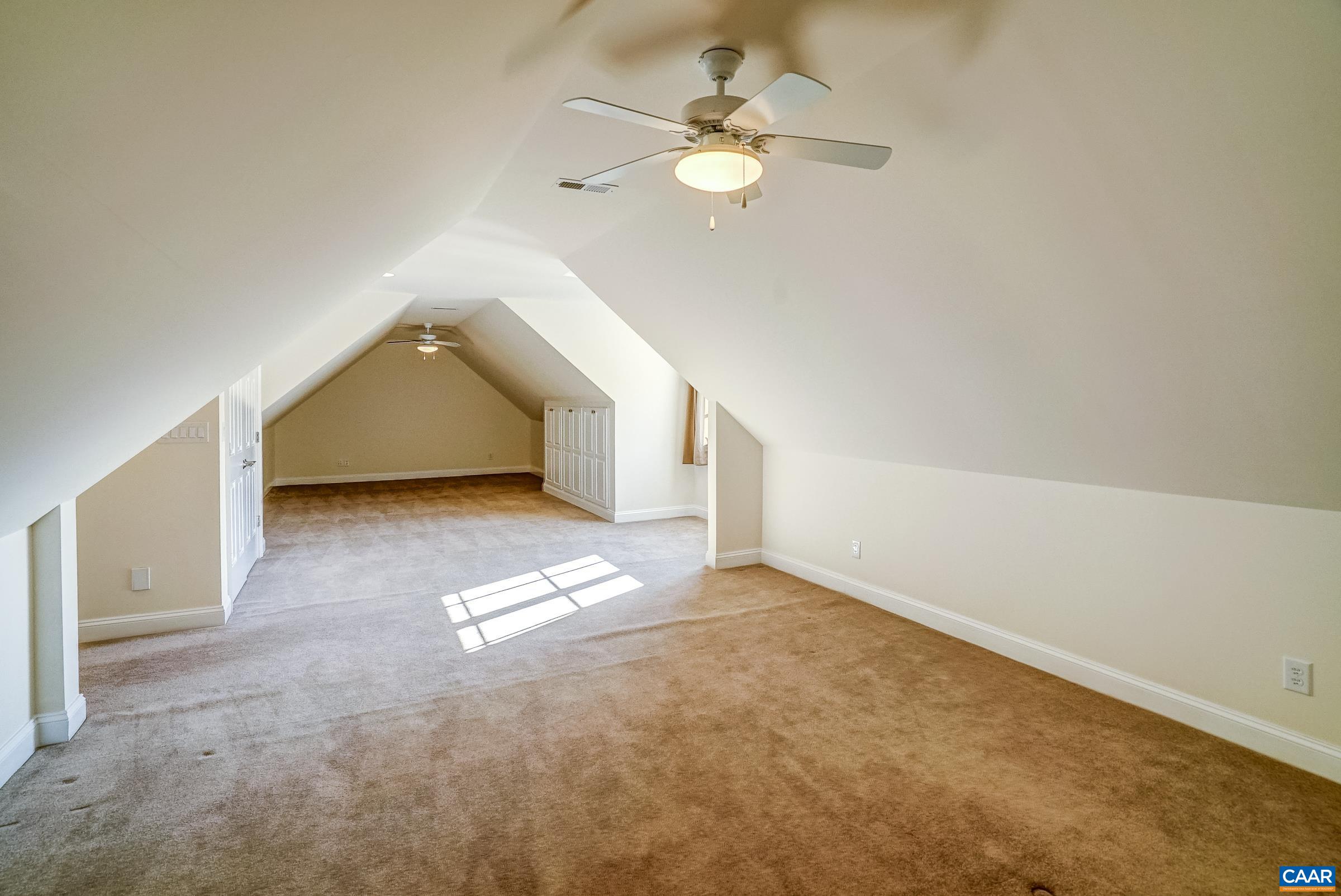 801 Half Mile Branch Road Crozet, VA 22932 - Photo 53 of 69 an empty room with a chandelier fan and windows