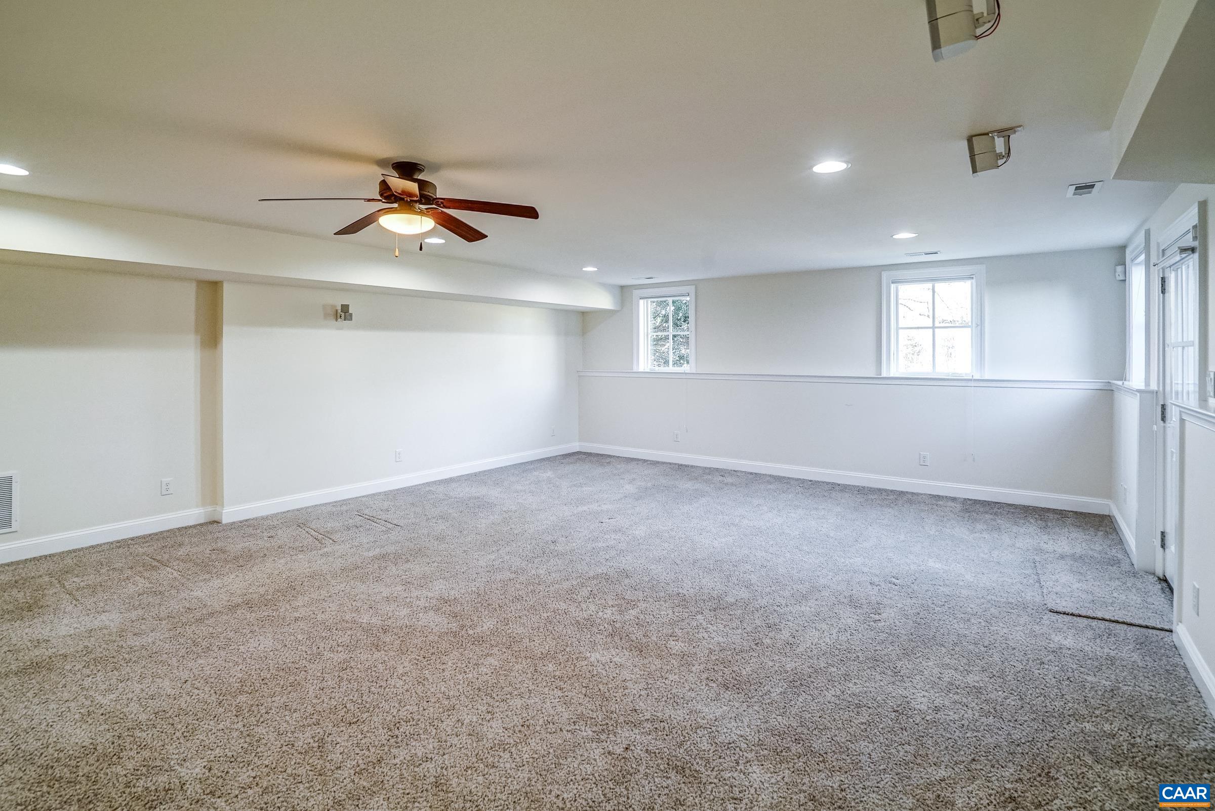801 Half Mile Branch Road Crozet, VA 22932 - Photo 58 of 69 an empty room with windows and ceiling fan