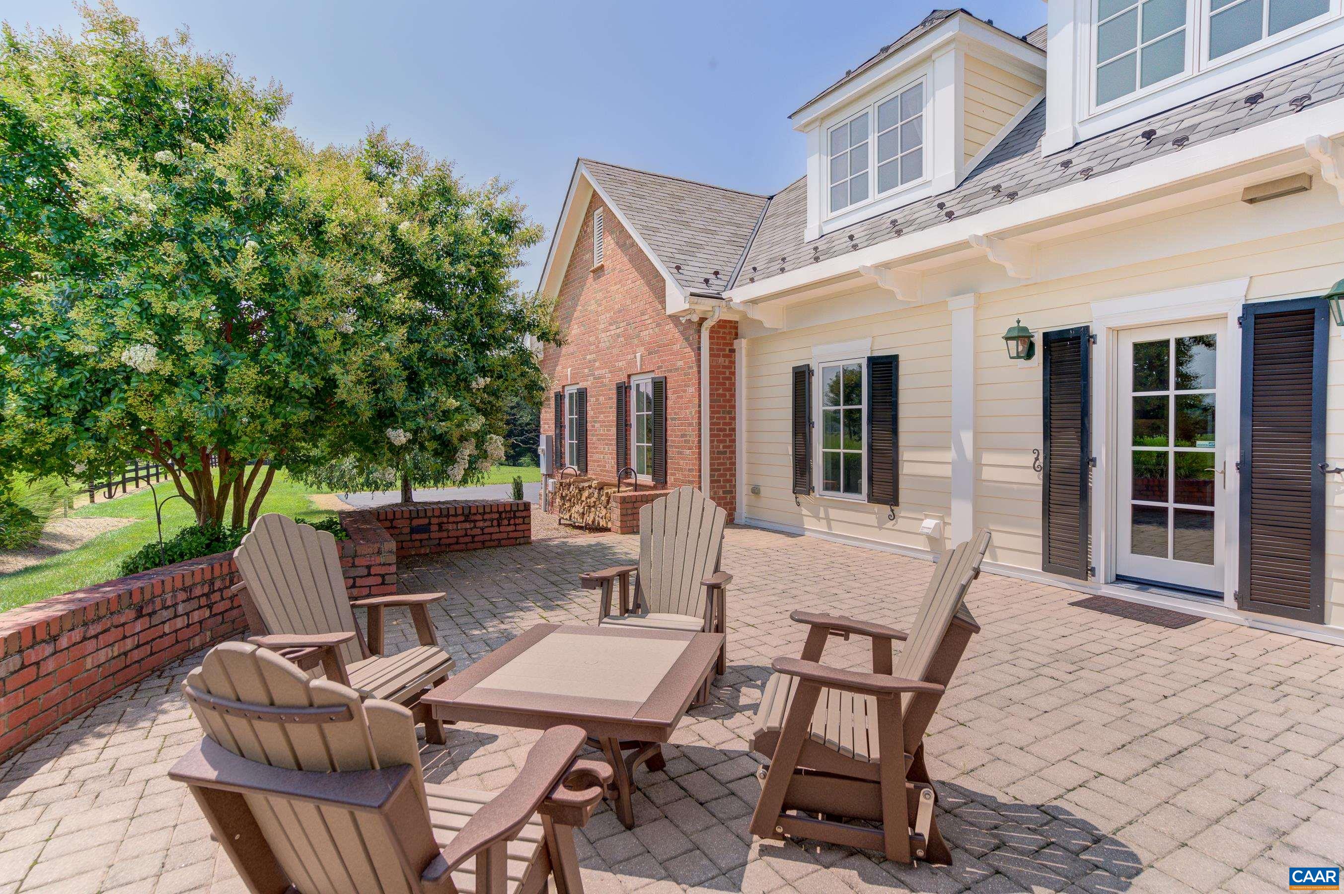 801 Half Mile Branch Road Crozet, VA 22932 - Photo 7 of 69 a view of a patio with couches table and chairs and potted plants