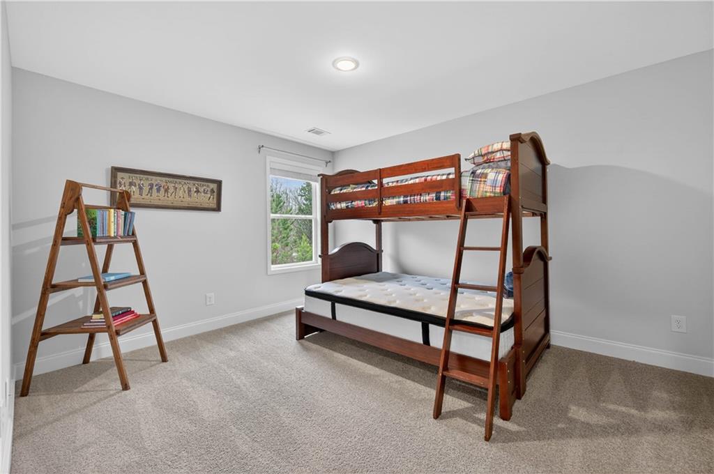 223 Timber Ridge Dawsonville, GA 30534 - Photo 17 of 24 a bedroom with furniture and a window