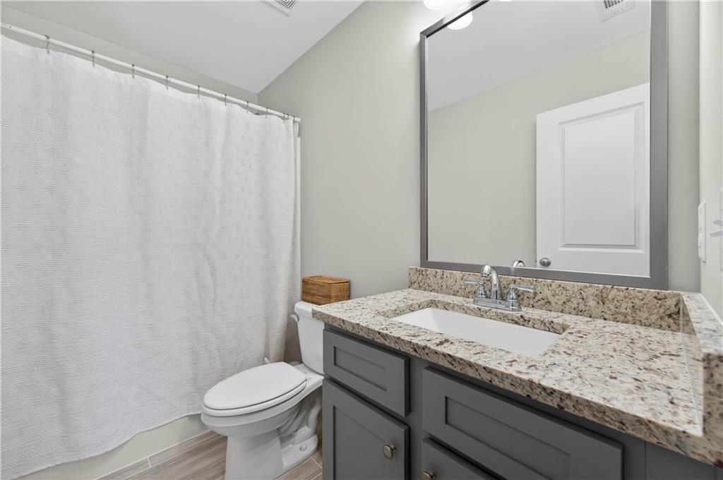 223 Timber Ridge Dawsonville, GA 30534 - Photo 18 of 24 a bathroom with a granite countertop sink toilet and a mirror
