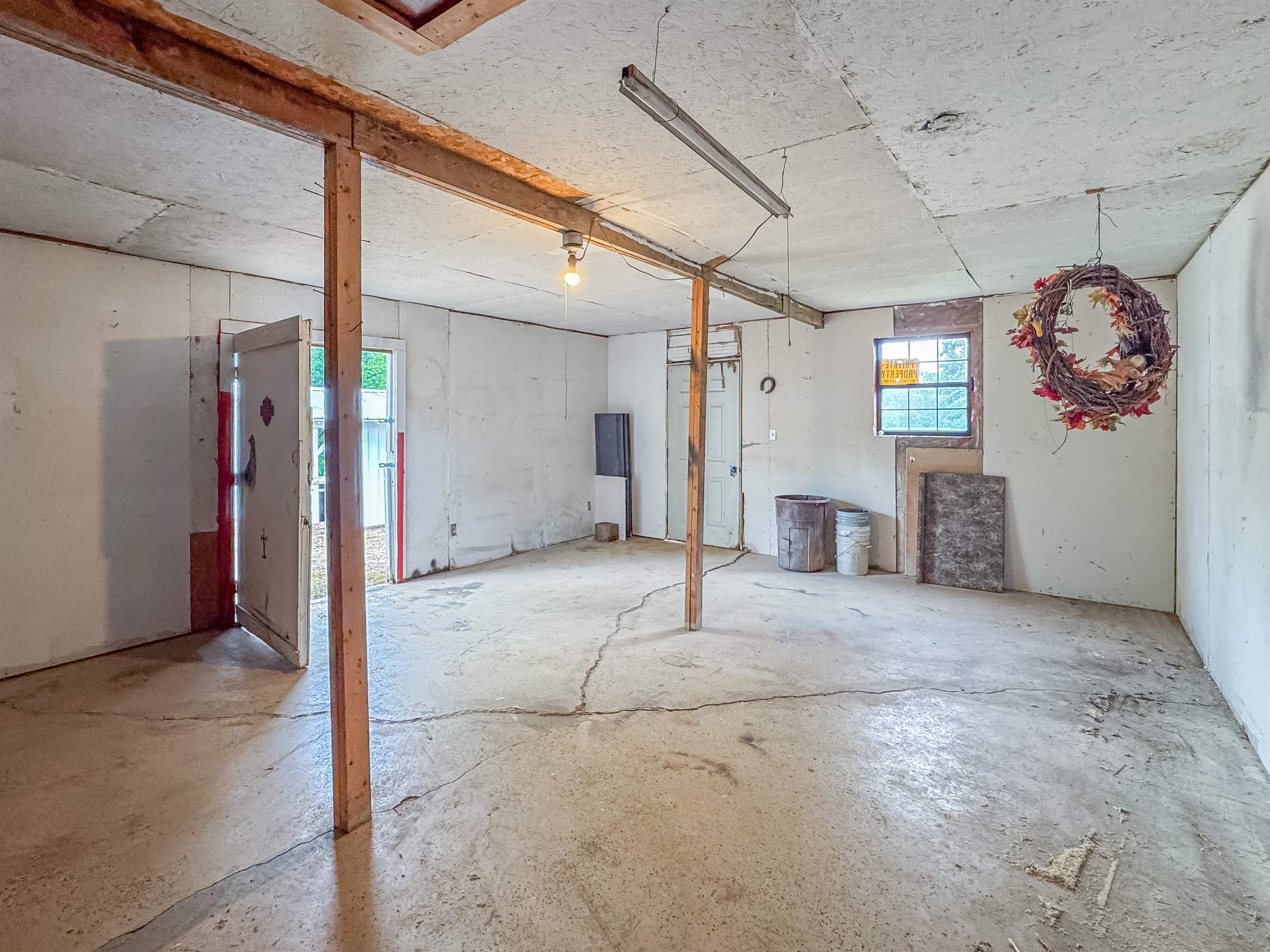 6264 45th Highway South Ramer, TN 38367 - Photo 21 of 24 Spacious open-concept room featuring concrete flooring and exposed ceiling beams