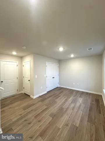 a bathroom with a sink mirror toilet and next to a window