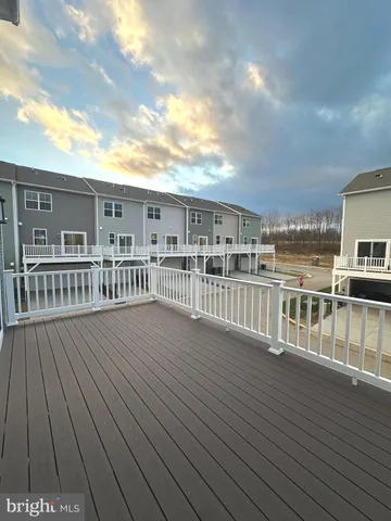 a view of a balcony with wooden floor