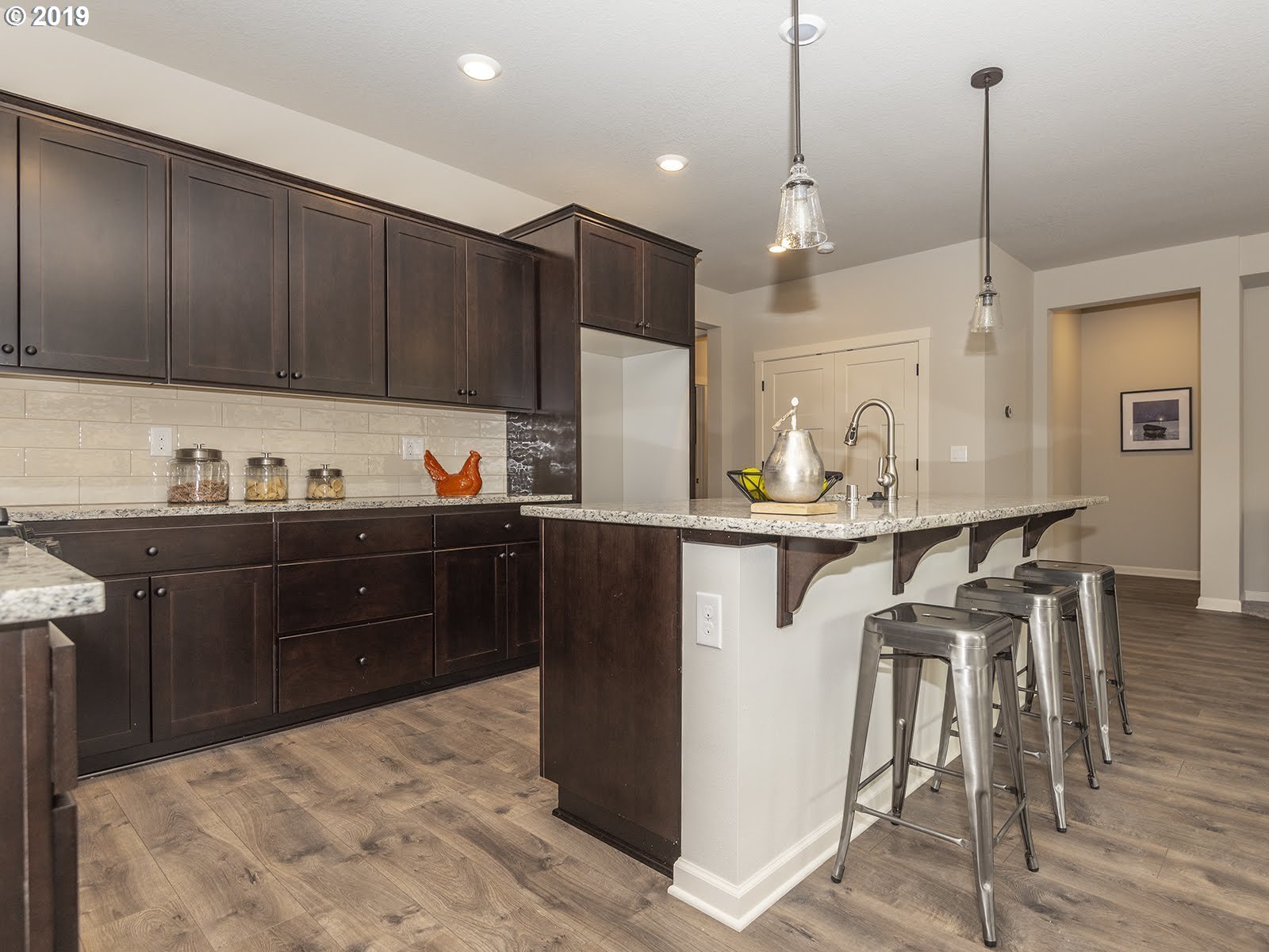 4119 Southwest Rodlun Road Gresham, OR 97080 - Photo 14 of 29 a kitchen with stainless steel appliances kitchen island granite countertop a refrigerator a sink and wooden cabinets