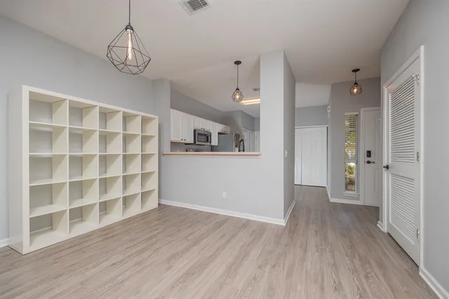 a view of wooden floor and windows in a room