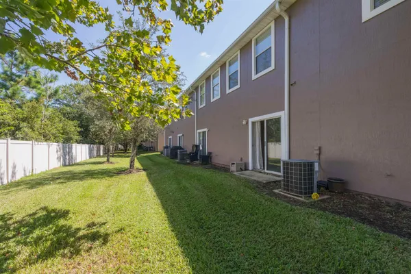a backyard of a house with table and chairs