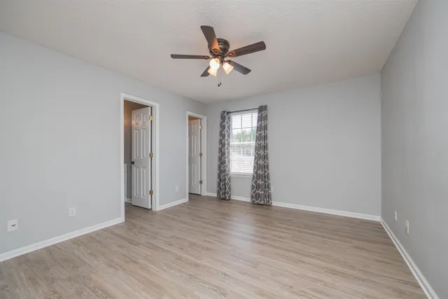wooden floor in an empty room with a window