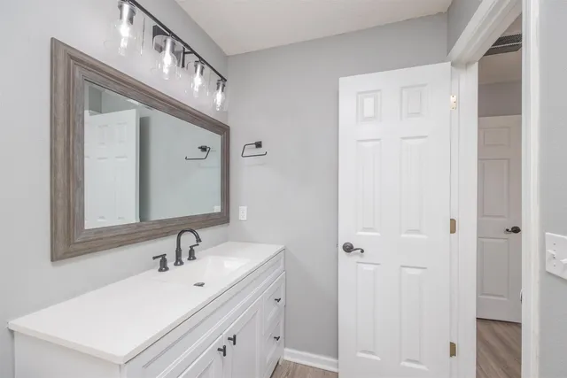 a bathroom with a sink vanity and a mirror