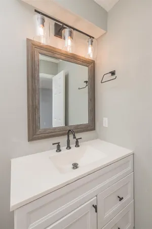 a bathroom with a sink vanity and a mirror