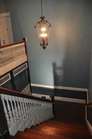 a view of staircase with white walls and a window