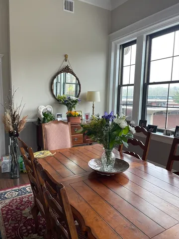 a view of a dining room with furniture window and wooden floor