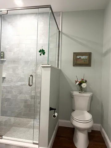 a bathroom with a toilet a sink and shower