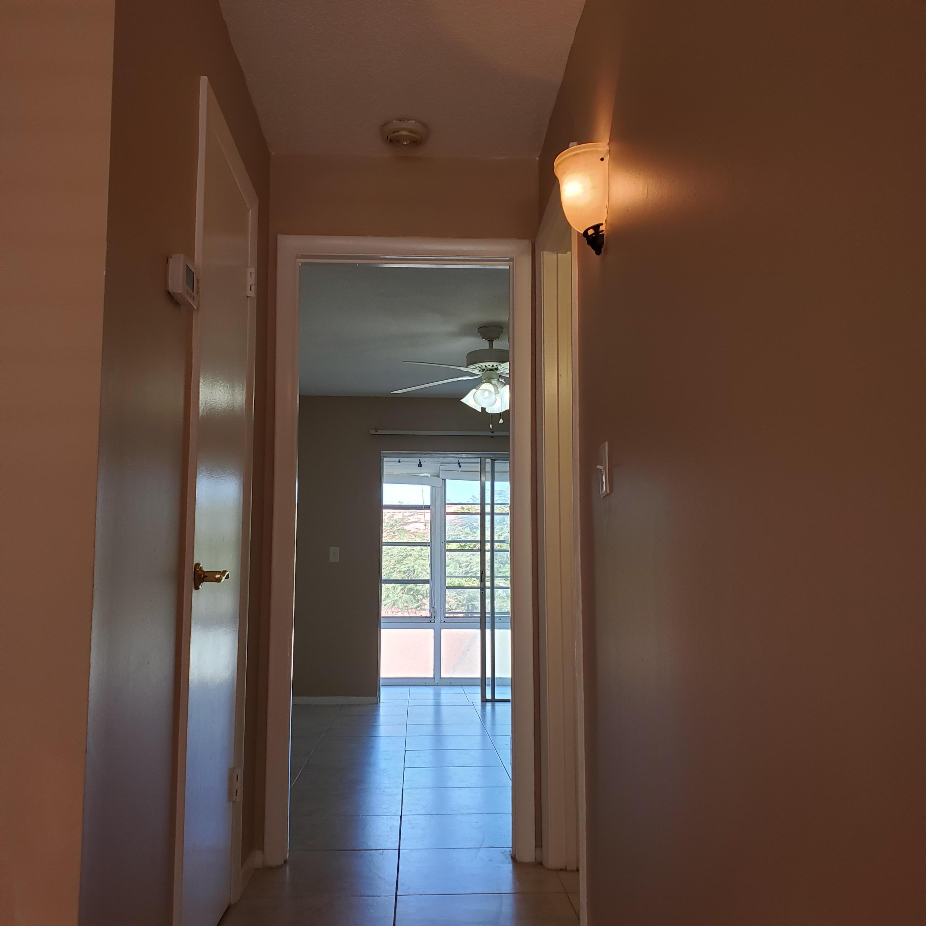 2600 Southeast Ocean Boulevard, Unit A11 Stuart, FL 34996 - Photo 11 of 62 a view of empty room with wooden floor and fan