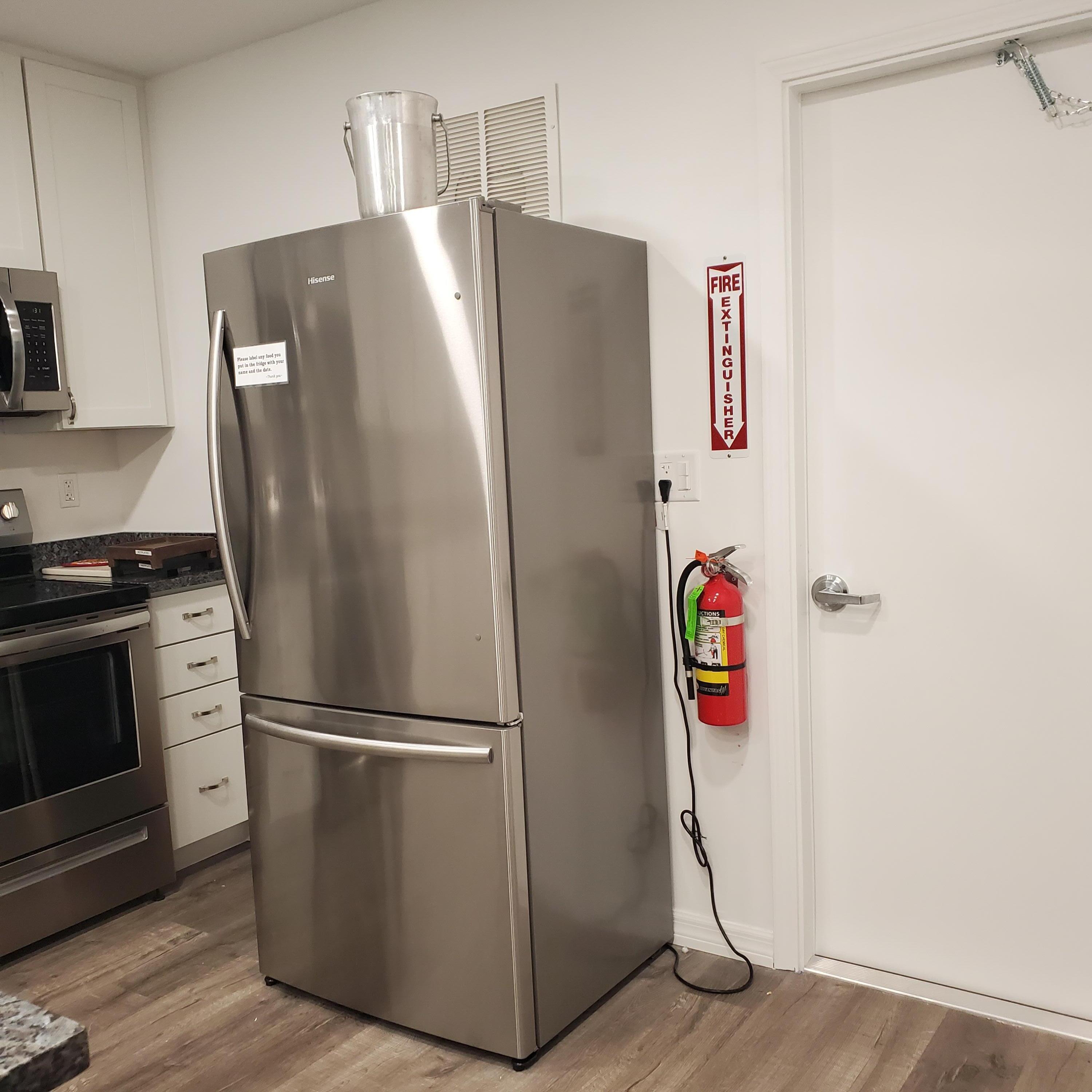 2600 Southeast Ocean Boulevard, Unit A11 Stuart, FL 34996 - Photo 42 of 62 a metallic refrigerator freezer sitting in a kitchen