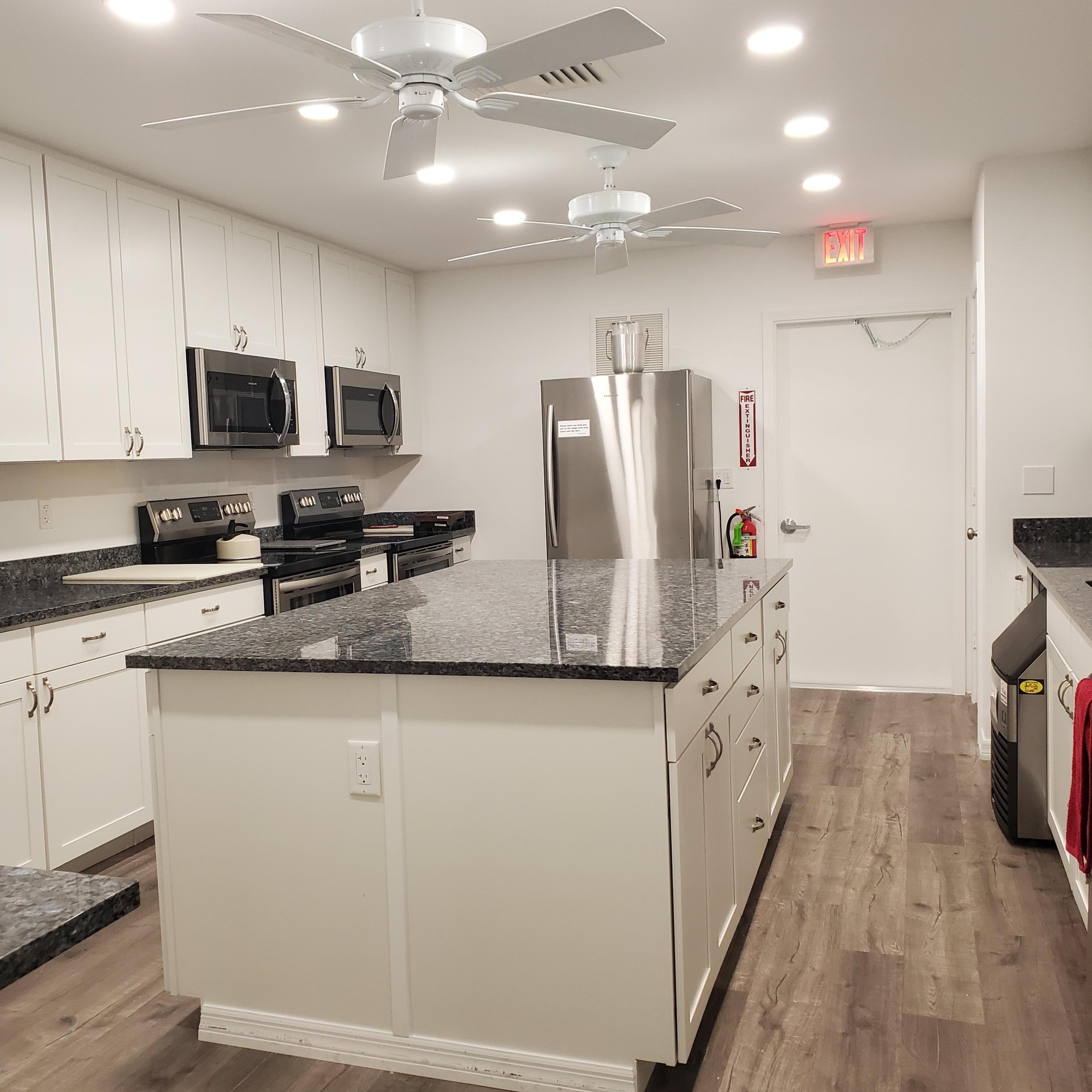 2600 Southeast Ocean Boulevard, Unit A11 Stuart, FL 34996 - Photo 44 of 62 a kitchen with stainless steel appliances granite countertop a refrigerator a stove top oven a sink and dishwasher