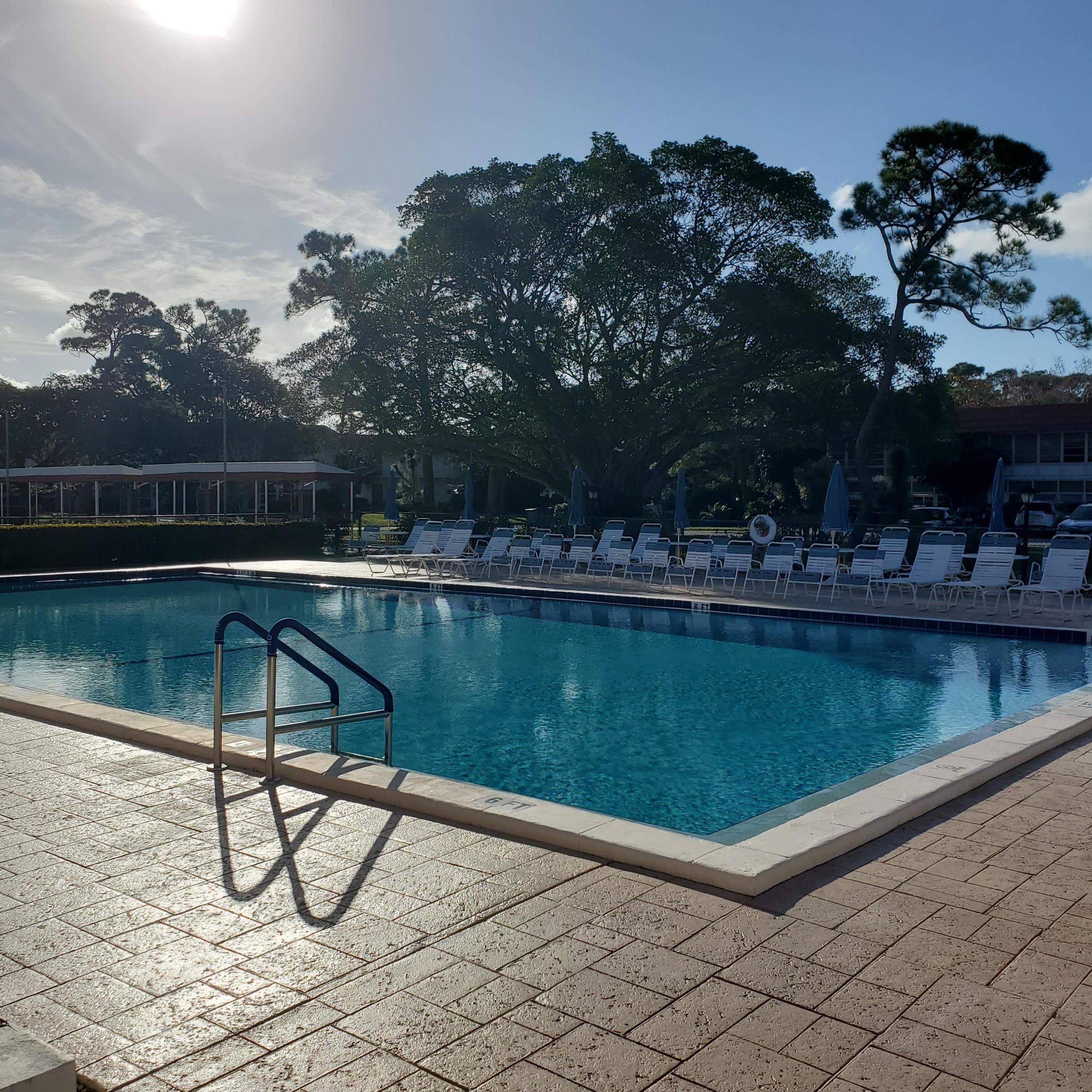 2600 Southeast Ocean Boulevard, Unit A11 Stuart, FL 34996 - Photo 52 of 62 a view of a lake with a bench and trees