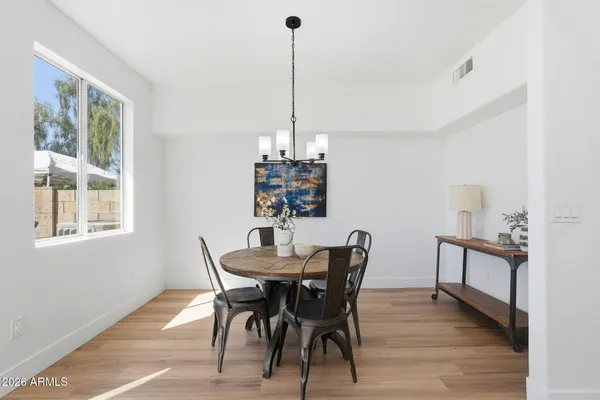 a view of a dining room with furniture window and wooden floor