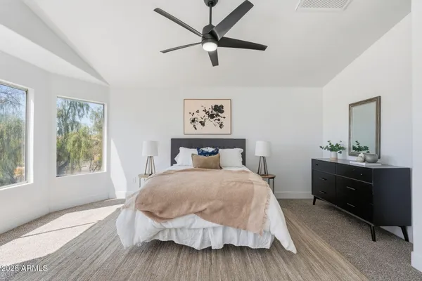 a bedroom with a bed and a dresser