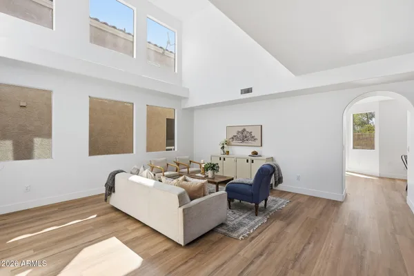 a living room with furniture and a wooden floor