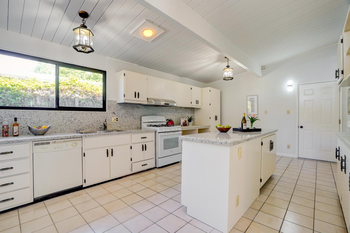 721 Stendhal Lane Cupertino, CA 95014 - Photo 26 of 54 a kitchen with white cabinets a sink dishwasher and a stove with wooden floor