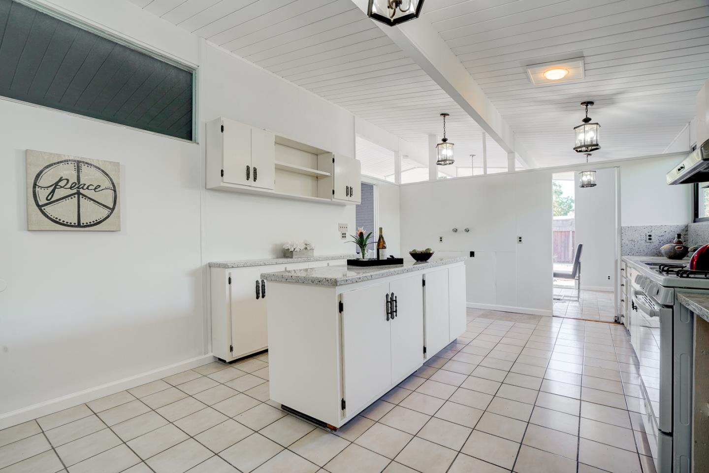 721 Stendhal Lane Cupertino, CA 95014 - Photo 28 of 54 a large white kitchen with a stove a sink dishwasher and a refrigerator with wooden floor