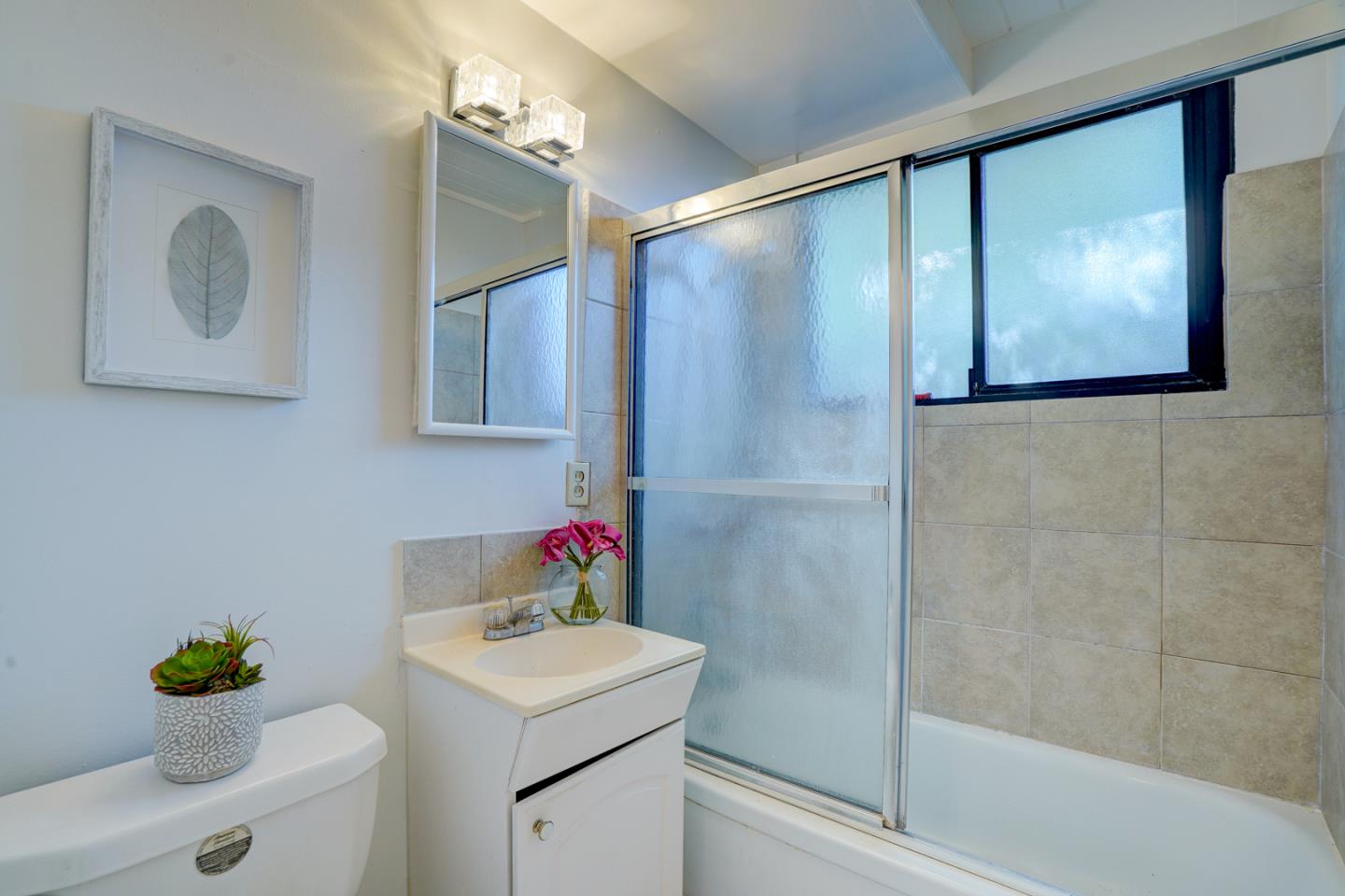 721 Stendhal Lane Cupertino, CA 95014 - Photo 32 of 54 a bathroom with a sink mirror vanity and toilet