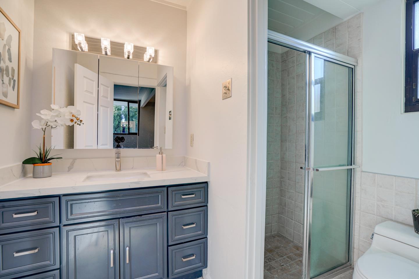 721 Stendhal Lane Cupertino, CA 95014 - Photo 42 of 54 a bathroom with a granite countertop sink mirror and toilet