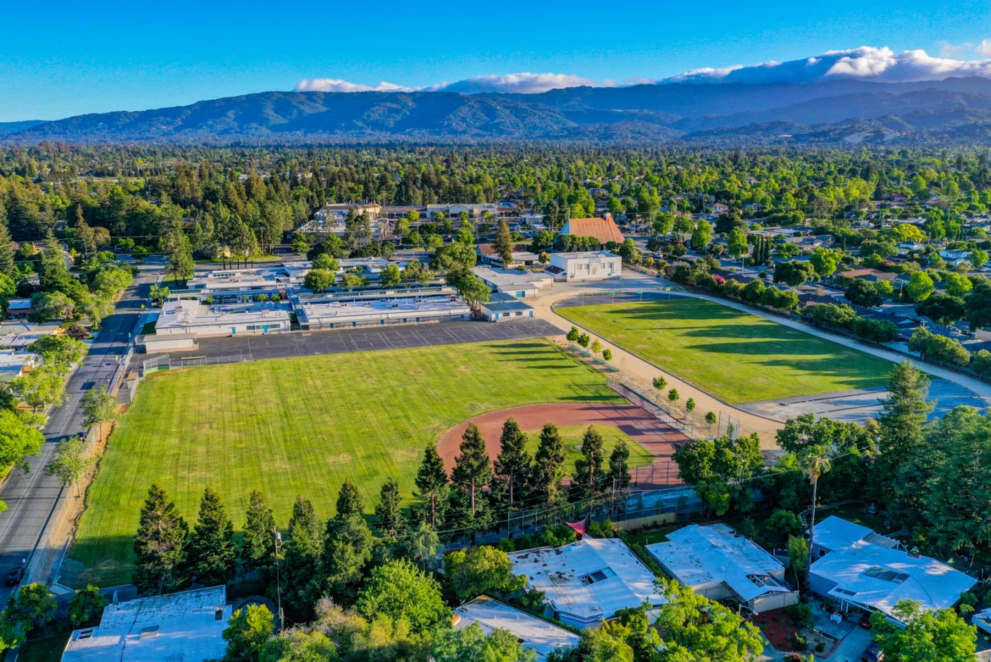 721 Stendhal Lane Cupertino, CA 95014 - Photo 51 of 54 a view of a swimming pool with a table and chairs under an umbrella