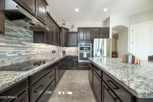 a view of a kitchen with a sink and a large window