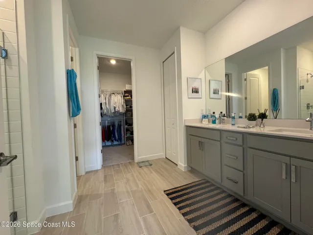 a spacious bathroom with a double vanity sink and a mirror