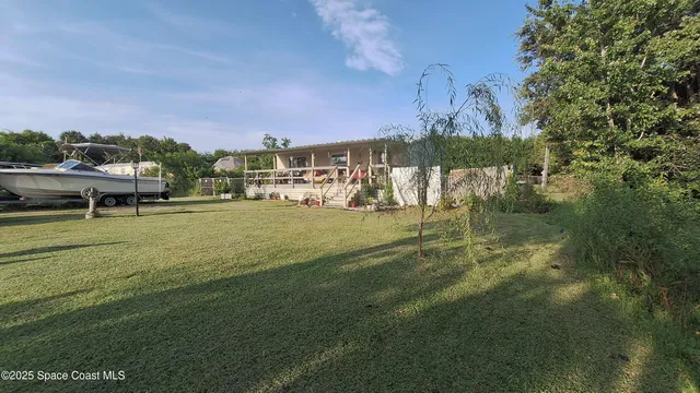 a view of a big yard with table and chairs