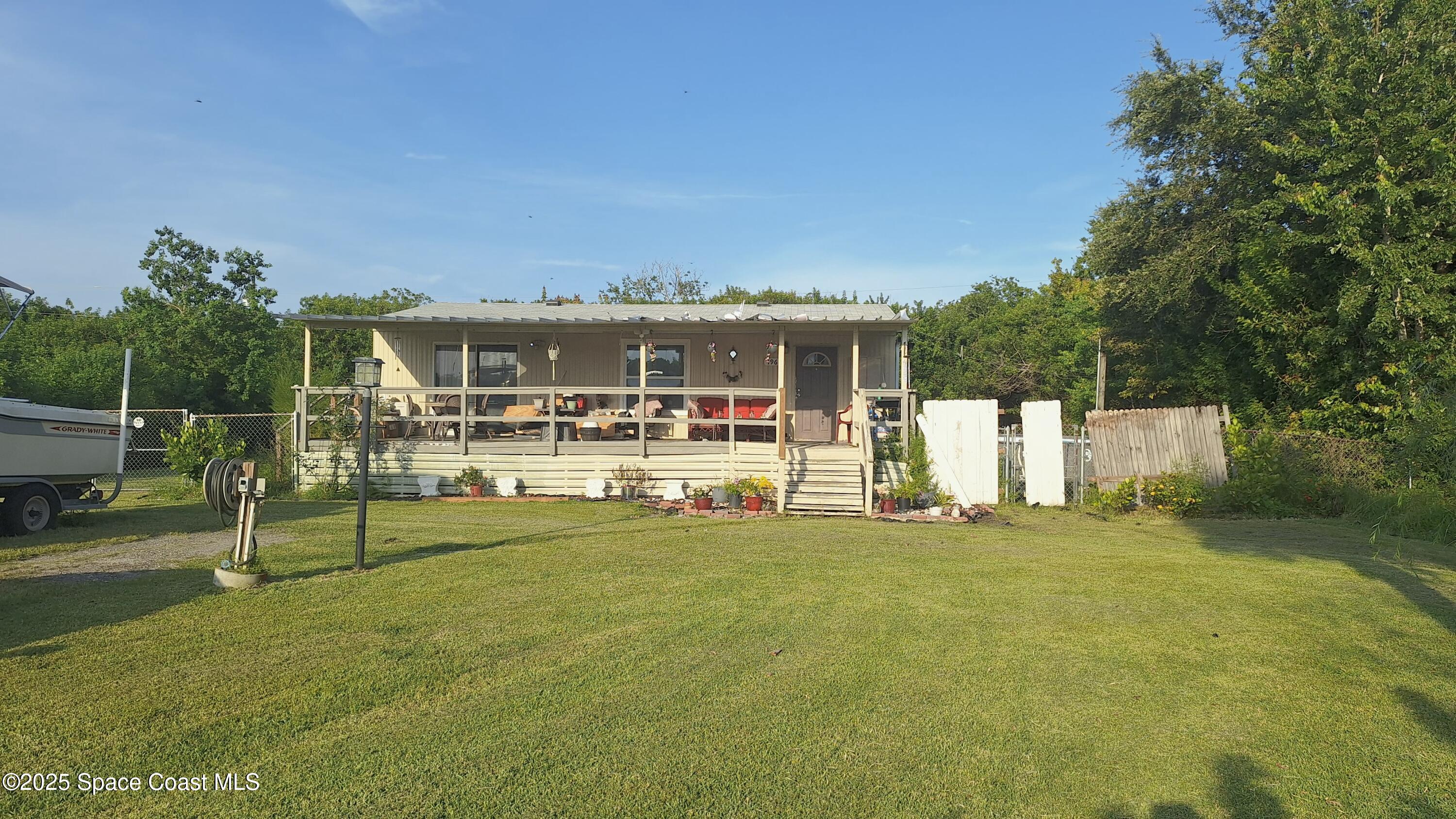 1965 Hammock Road Titusville, FL 32796 - Photo 2 of 12 a view of a house with a yard