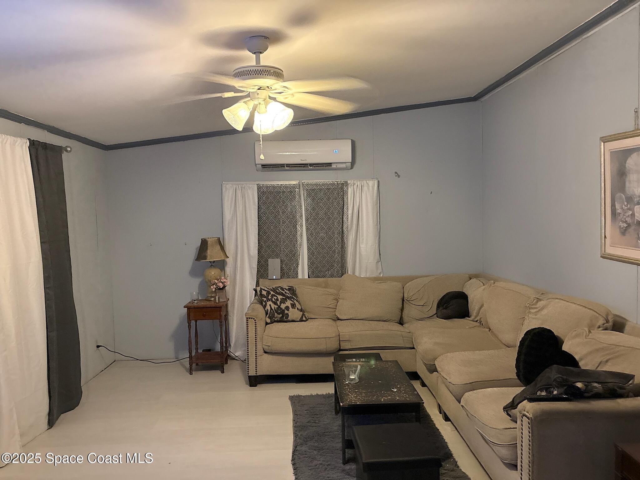 1965 Hammock Road Titusville, FL 32796 - Photo 5 of 12 a living room with furniture and a chandelier