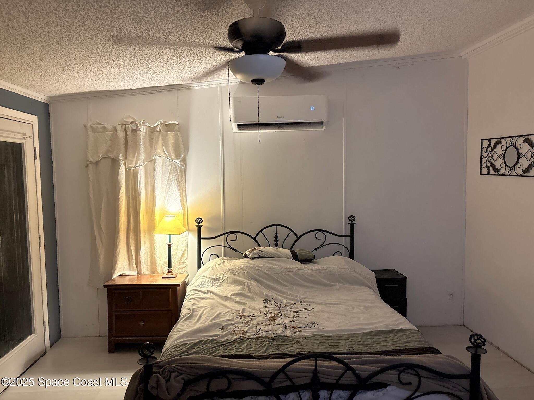 1965 Hammock Road Titusville, FL 32796 - Photo 6 of 12 a bedroom with a bed and a window