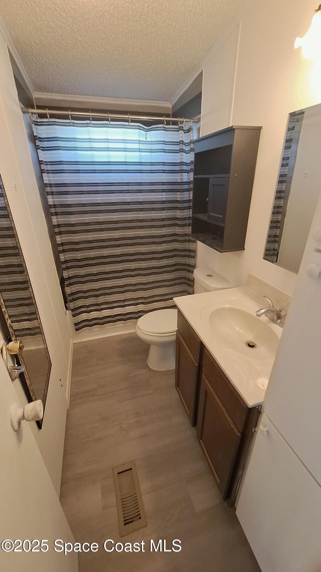 1965 Hammock Road Titusville, FL 32796 - Photo 10 of 12 a bathroom with a sink a toilet and shower