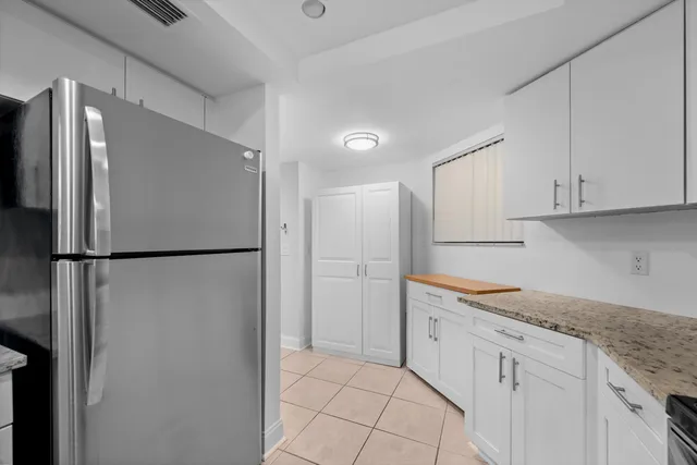a kitchen with a refrigerator and cabinets