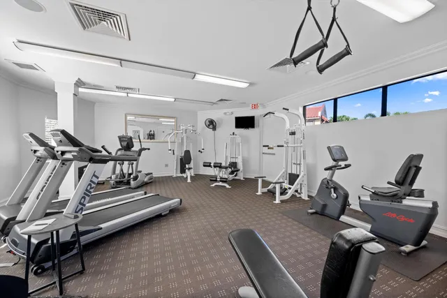 a living room with furniture gym equipment and a window
