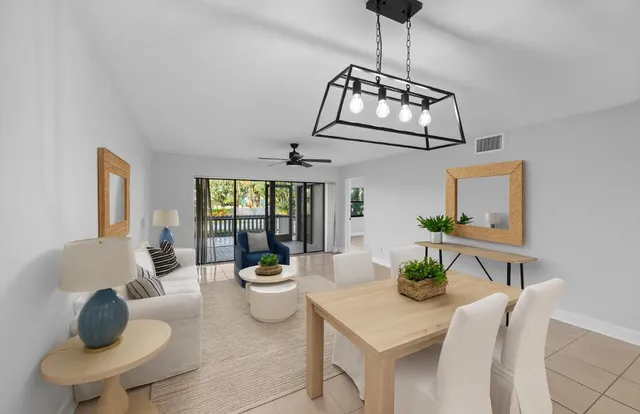 a living room with furniture and a chandelier